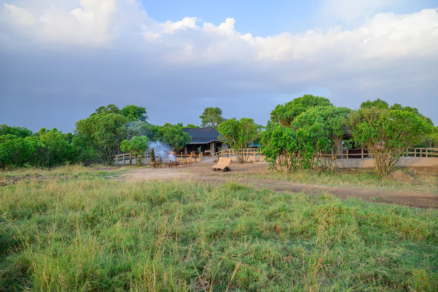 Tembo Bush Camp under its dark canvas, seen across the grass