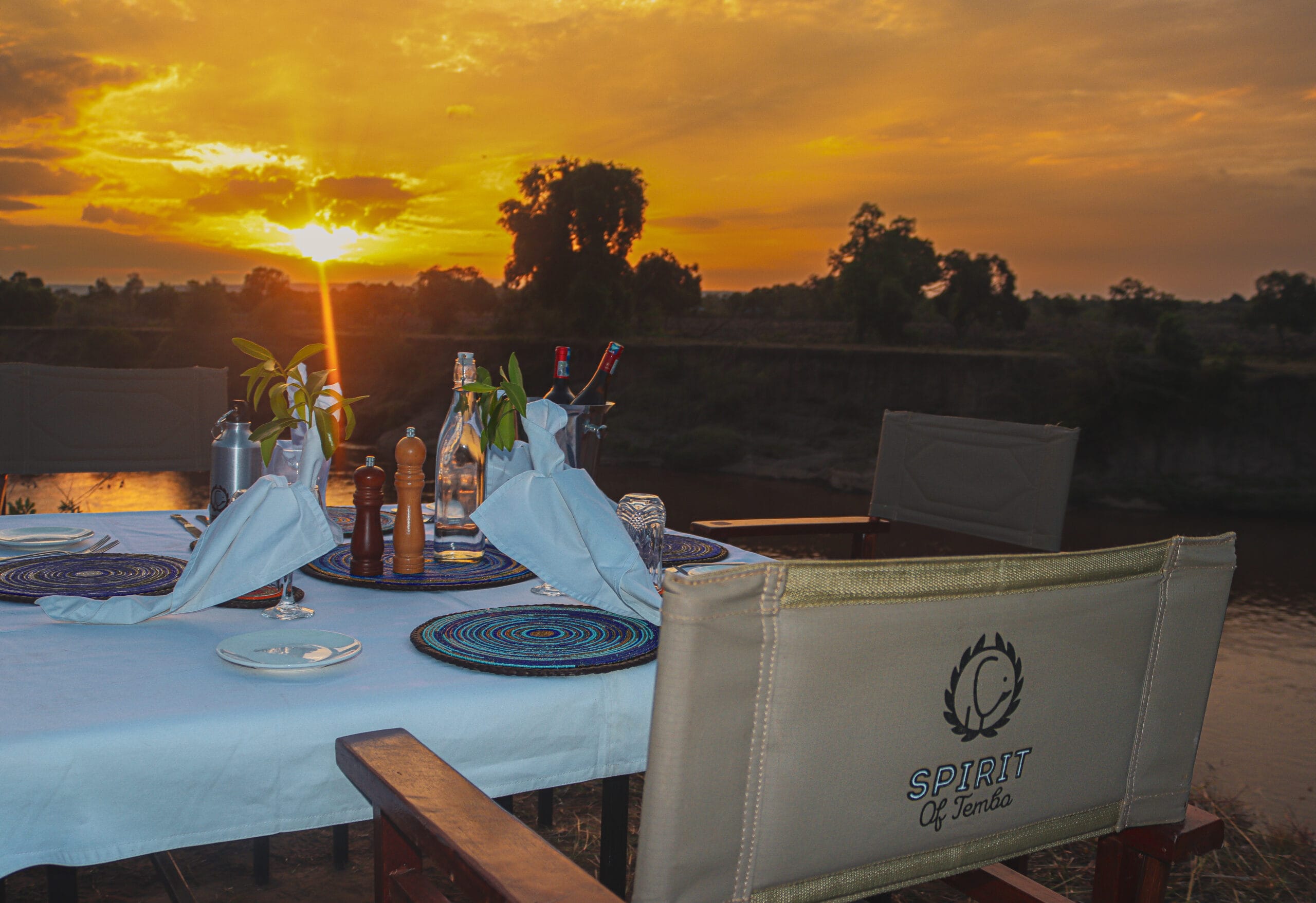 Sunset dining set up on the banks of the Mara River at Tembo Spirit Camp